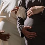 close-up of two pregnant women embracing the beauty of motherhood.