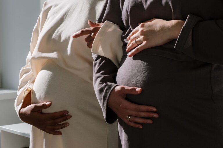 close-up of two pregnant women embracing the beauty of motherhood.