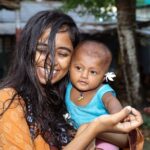joyful portrait of a woman and baby smiling outside in manikganj, bangladesh.