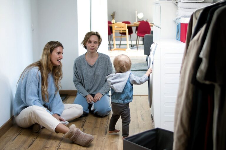 a mother and friend enjoy quality time with a toddler in a cozy home setting.