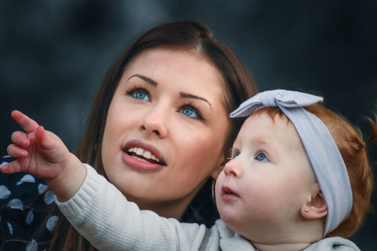 a touching portrait of a mother and her baby engaging with curiosity and wonder.