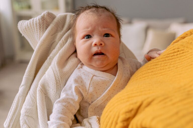 cute baby swaddled in a knitted blanket, portraying warmth and innocence.