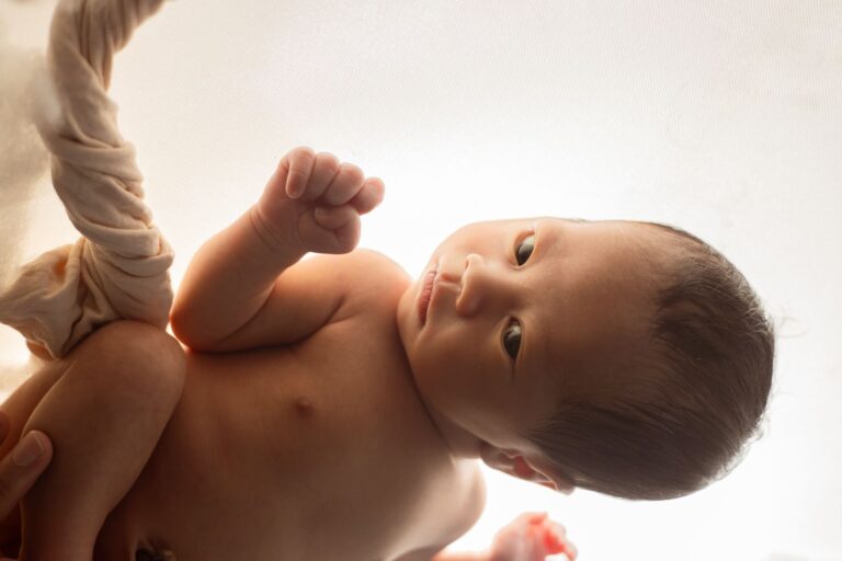 a sweet newborn baby wrapped in silk, sleeping peacefully in ho chi minh city studio.