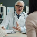 doctor discusses with family during a medical consultation. professional healthcare setting.