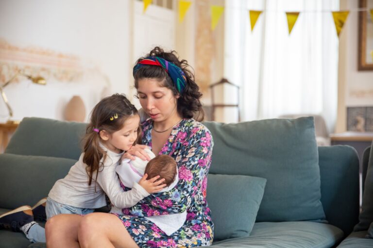 a mother with her children sitting on a couch, sharing a tender moment filled with love and warmth.