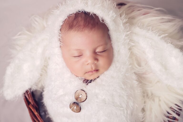 peaceful sleeping baby in a fluffy white costume, capturing pure innocence and comfort.