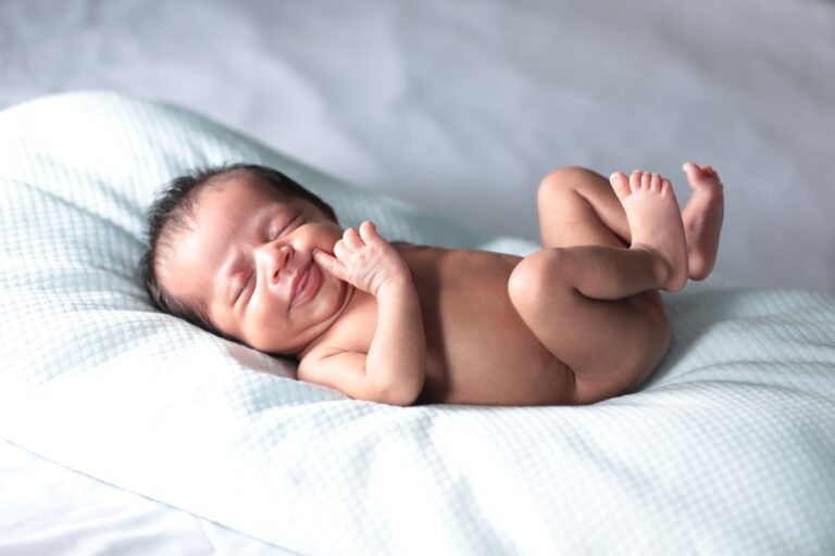 a heartwarming image of a newborn baby sleeping on a pillow, conveying comfort and purity.