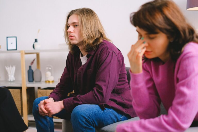 a worried couple sitting during a therapy session, expressing concern.