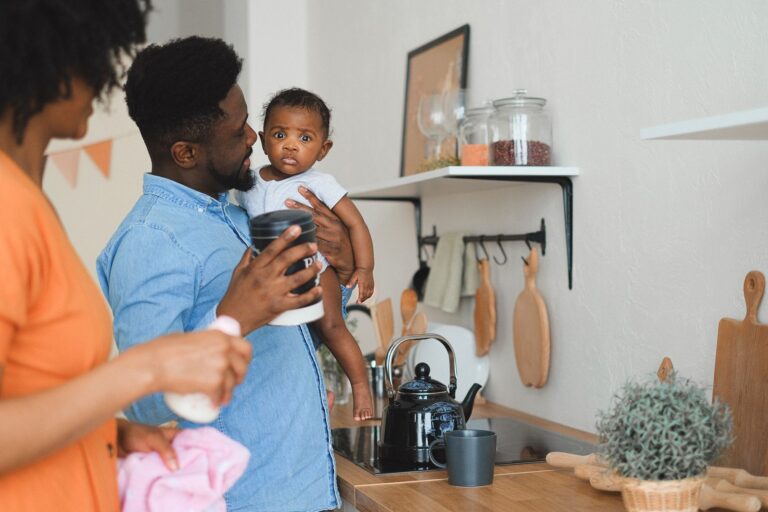 a family enjoying quality time in the kitchen with their baby.