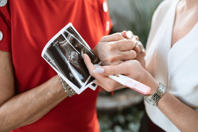 a touching moment of a pregnancy announcement with ultrasound and positive test.