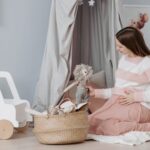 pregnant woman in a cozy nursery setting, surrounded by toys, symbolizing anticipation and motherhood.