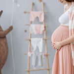 expectant mother caressing her belly in a cozy nursery room setting, symbolizing love and anticipation.