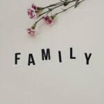 elegant arrangement of pink flowers and family text on a white background, ideal for family themes.