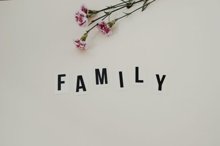 elegant arrangement of pink flowers and family text on a white background, ideal for family themes.
