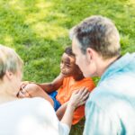a family moment with a child and adults bonding outdoors during a sunny day.