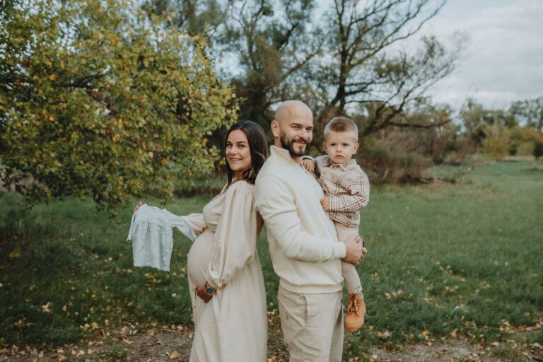 pregnant mother, father, and son in a serene outdoor setting, celebrating family joy.