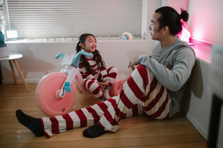 father and daughter enjoying quality time indoors in striped pajamas, family joy and togetherness.